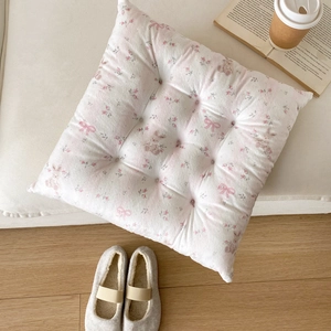 Close-up of a floral bear pattern square cushion with 9-hole tufting on a plush surface