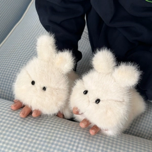 Close-up of cute plush bunny gloves with soft faux fur texture and adorable bead eyes