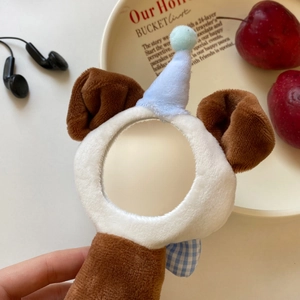 Detail of cute plush animal cover for mini makeup mirror with blue bow and soft fur
