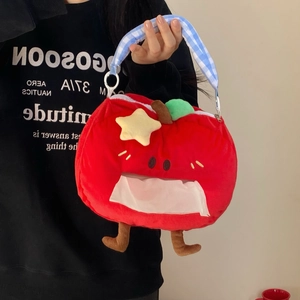 Detail of red apple plush tissue holder with blue checkered handle and paper outlet