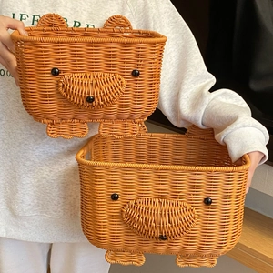 Close-up of bear-shaped woven storage baskets showing fine faux rattan texture and details