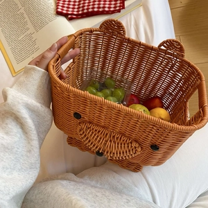 Detailed view of a bear-shaped woven basket filled with assorted fresh fruits on a table