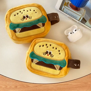 Detail of plush hamburger camera bag featuring soft material and portable hand strap