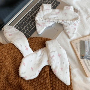 Detailed view of cute rabbit ear headband and frilly hairband with angel print