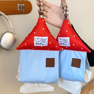 Detail of house-shaped fabric tissue box holder with polka dot roof and hanging strap