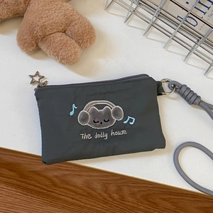 Detail of grey cat mini pouch with star zipper and embroidered earphone storage bag
