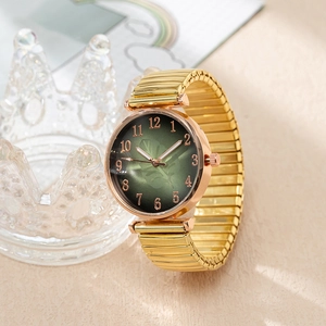 Detail of vintage green leaf dial and golden elastic expansion band fashion watch