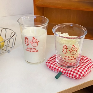 Detail of Christmas snowman glass cups with festive prints for milk and coffee serving