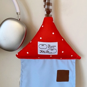 Close-up of house-shaped fabric tissue box with polka dot roof and hanging strap