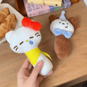 Detailed view of plush animal baby rattle toys including a white cat and brown puppy