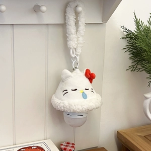 Detail of cartoon cat plush wall night light with red bow and soft textured faux fur