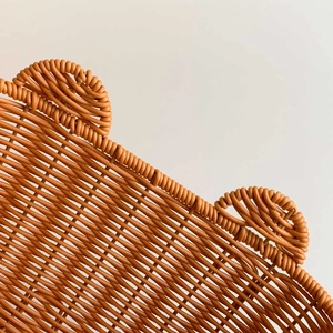 Detailed macro shot of the durable orange-brown woven texture and cute bear ear design