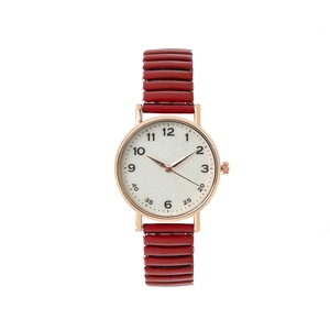Detailed shot of red elastic band watch with white dial and rose gold metal case