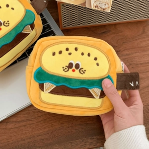 Close-up of burger-shaped plush camera bag with embroidery and webbing handle