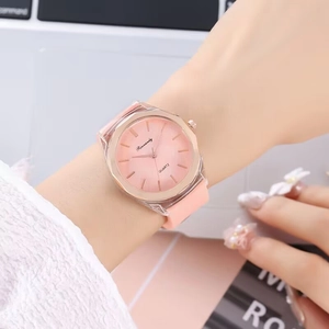 Pink silicone quartz watch for women with transparent case and sunburst dial detail