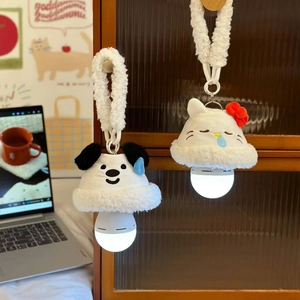 Detail of plush cartoon night lights featuring a puppy and rabbit on a wooden cabinet