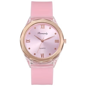 Detailed macro view of pink quartz watch with silicone strap and Roman numeric dial