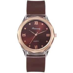Detail of rose gold polygonal bezel and brown silicone strap on quartz watch