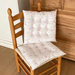 Detail of floral chair cushion set with cute bunny print and quilted button design