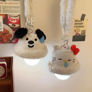 Close-up of cute plush cartoon character wall lamps with warm glowing lights for bedroom