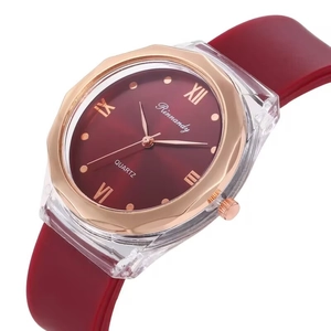 Detail of red sunburst dial and rose gold octagonal bezel on women's quartz watch