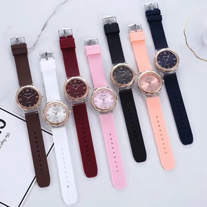 Set of seven silicone strap watches in various colors on marble background