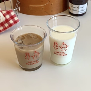 Detail of Christmas snowman glass cup with holiday patterns for coffee and milk