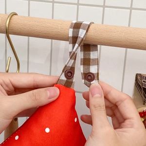 Hanging polka dot tissue holder with red fabric house design and adjustable strap