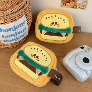 Detailed close-up of hamburger plush camera pouch with soft texture and embroidery