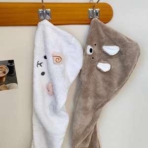 Detailed texture of thick coral fleece hair towel with cute animal embroidery on hooks
