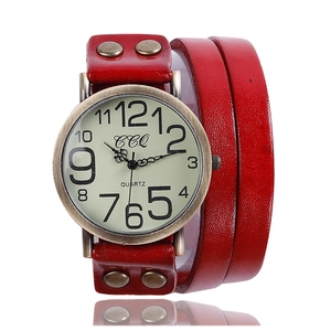 Macro detail of red multilayer leather strap with bronze studs and quartz watch case