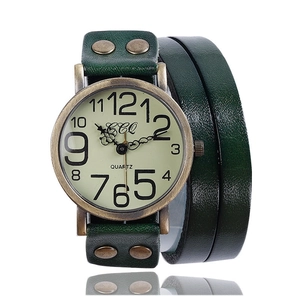 Detail view of vintage multi-layer green leather watch strap with retro metal rivets