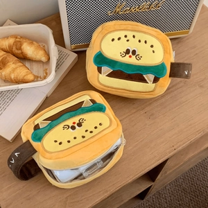 Cute plush hamburger and sandwich camera bags on a cozy wooden tabletop setting