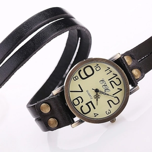 Macro shot of retro quartz watch with bronze rivets on a triple-wrap black leather strap