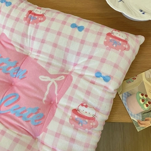 Detail of Hello Kitty pink checkered plush chair cushion with Little Cute text embroidery