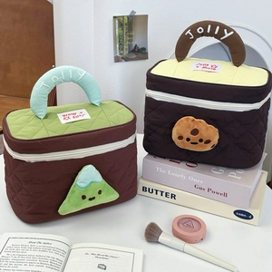 Close-up of quilted cosmetic bags with Jolly embroidery and cute plush cartoon details