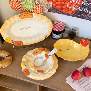 Detail of creative cartoon ceramic tableware set with embossed hot dog and chicken motifs