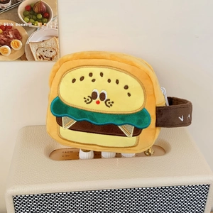 Detail of plush burger camera bag featuring cute cartoon embroidery and brown handle strap