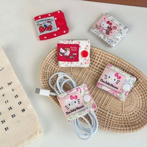 Detail of fabric cable organizers with cute cat labels and snap buttons in various patterns