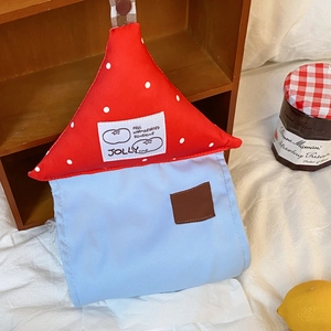 Detailed view of a creative house-shaped fabric tissue holder with red polka dot roof