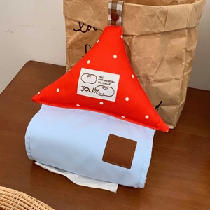 Close-up of a house-shaped tissue box cover featuring red polka dots and a blue fabric base