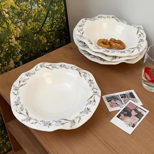 French vintage wavy ceramic plate with lavender floral pattern on white desktop