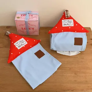 Close-up of cottage shape fabric tissue box with red polka dot roof and blue base