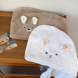 Detail of coral fleece hair drying towels featuring cute bear and sheep embroidery