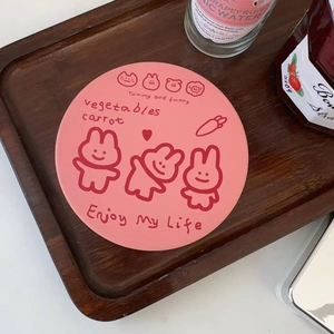 Pink ceramic coaster featuring cute cartoon rabbits on a rustic wooden tray setup