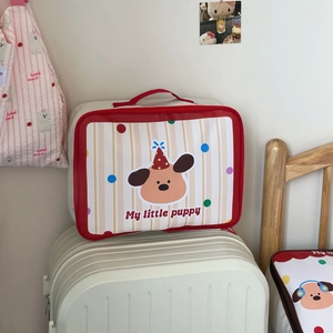 Detail of cute puppy travel bag with trolley sleeve on striped luggage suitcase