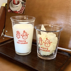 Detail of Christmas snowman glass cup with Merry Christmas print on wooden tray