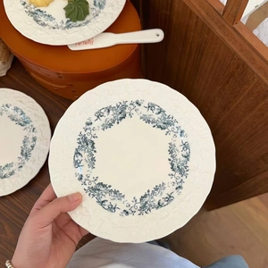 Elegant French vintage ceramic dinner plate with blue floral pattern and wavy edges