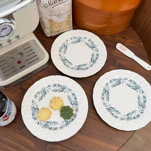 Macro shot of French floral ceramic plates with blue patterns in a kitchen setting