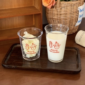 Detail of Christmas snowman glass cup featuring festive patterns and merry Christmas text